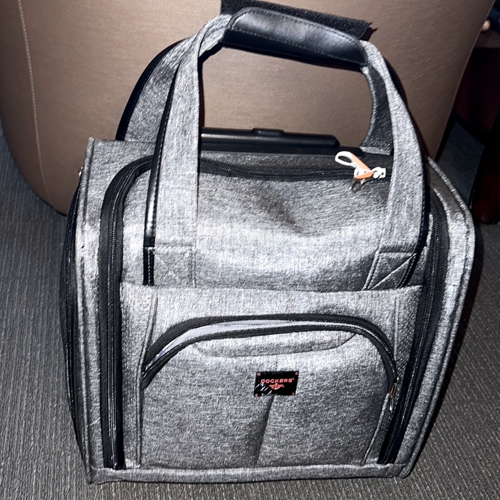 Dockers small carry on suitcase with wheels and a lot of pockets. Only used once